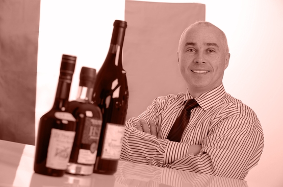 Louis-Pierre Laroche in front of bottles from his range