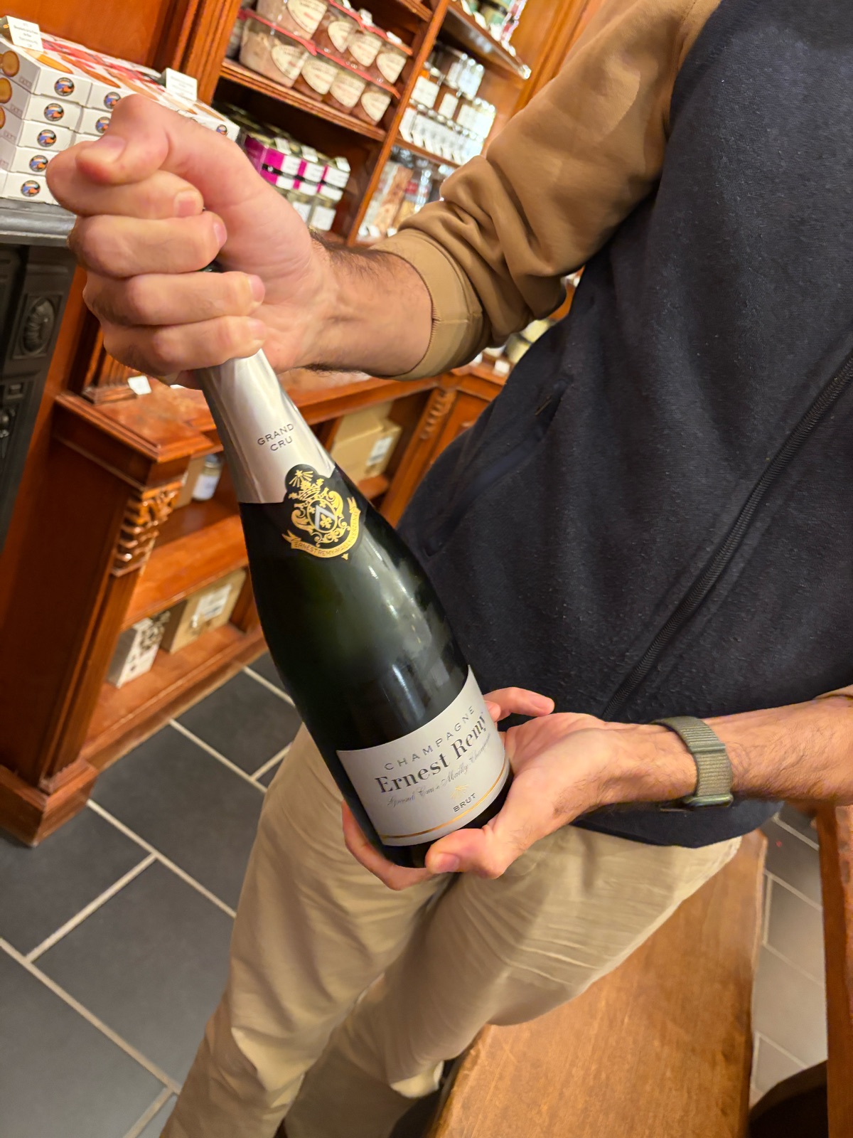 Alexander C. Schwarz holds a bottle of champagne and loosens the wire cage