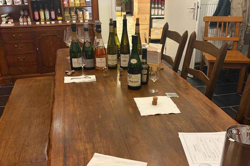 The wooden table in the store after the tasting: opened bottles, glasses and written sheets